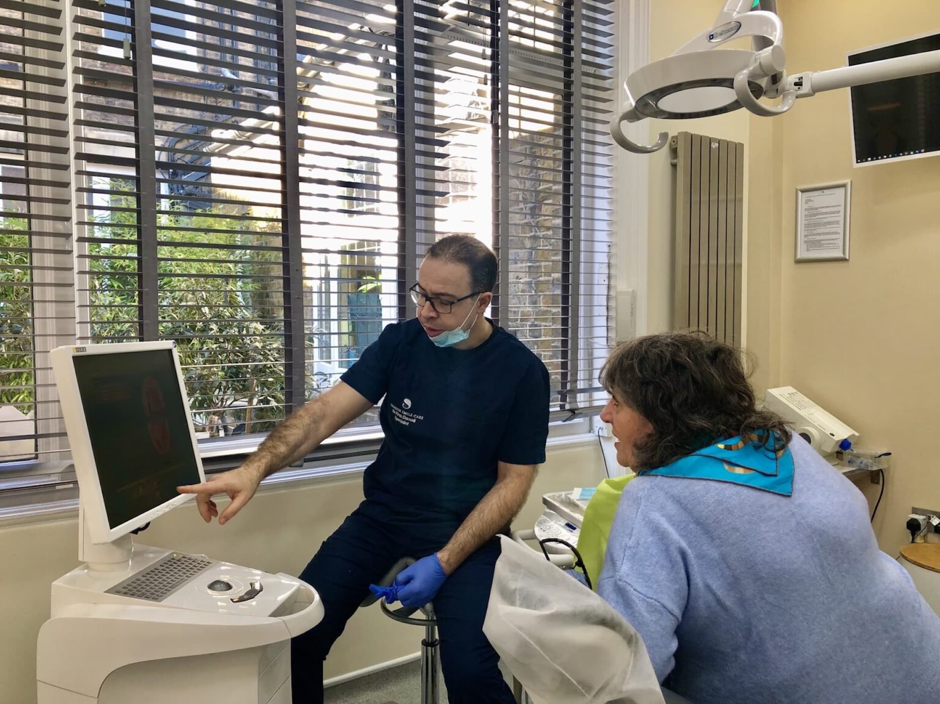 Dr Firas Daoudi reviewing a complex dental problem with a patient